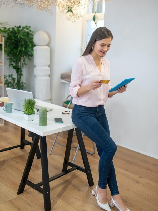 nice-positive-woman-entering-her-bank-card-number.jpg